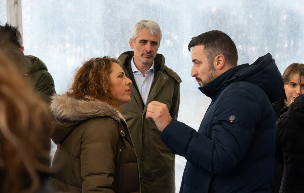 Conversación entre asistentes en la carpa del acto de extensión de la red móvil en Leiro, Ourense